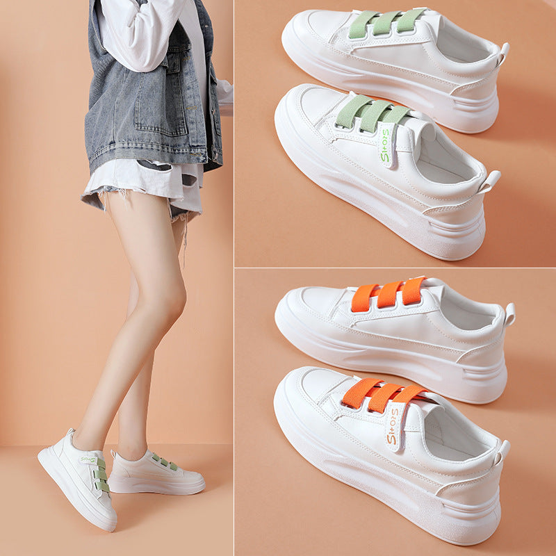 Pair of white women's platform sneakers with light green adjustable straps. Another pair with orange straps.