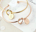 Personalized letter initial knot bangle bracelet featuring a heart charm