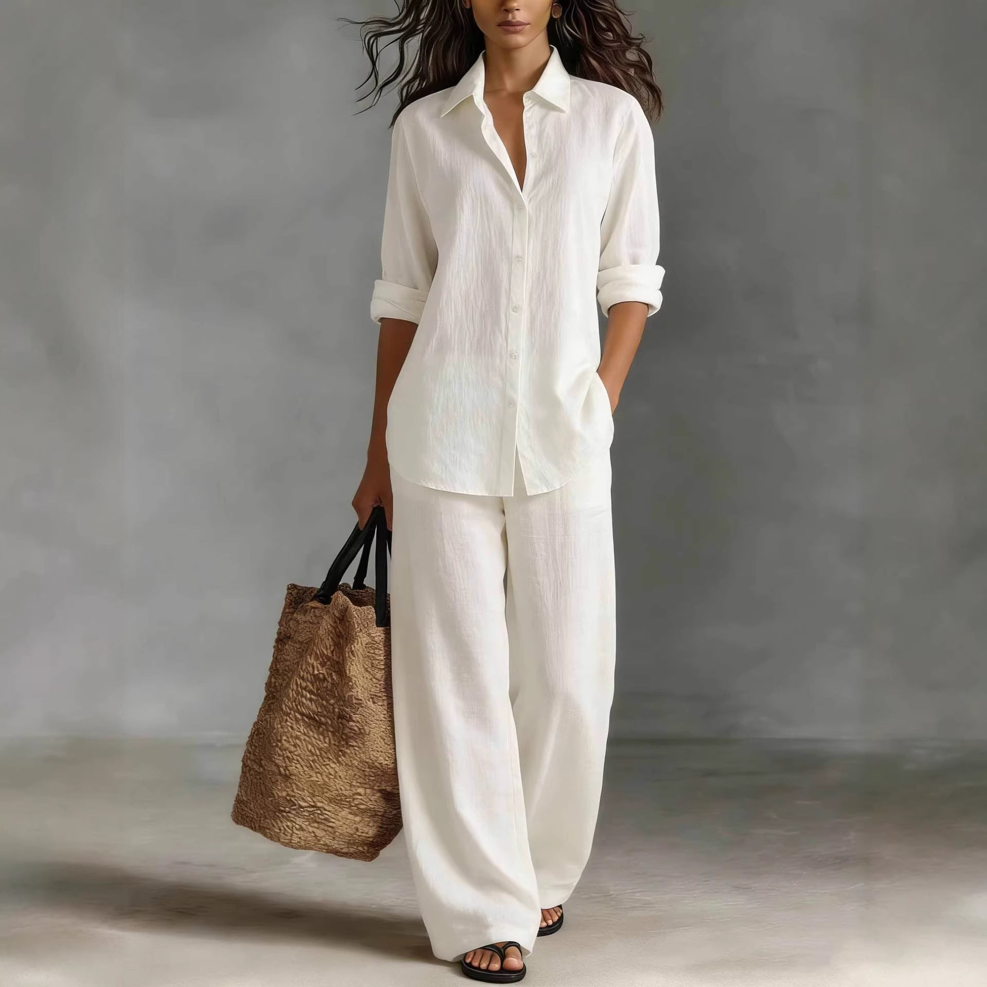 Model wearing a white bohemian cotton-linen button-down shirt and matching wide-leg pants