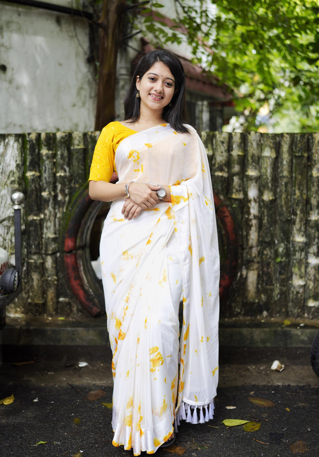 Yellow poly georgette tie and dye saree with satin pattu border