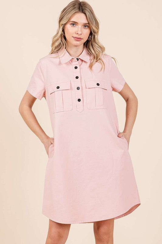 Close up of a collared short sleeve shirt dress featuring button detailing.