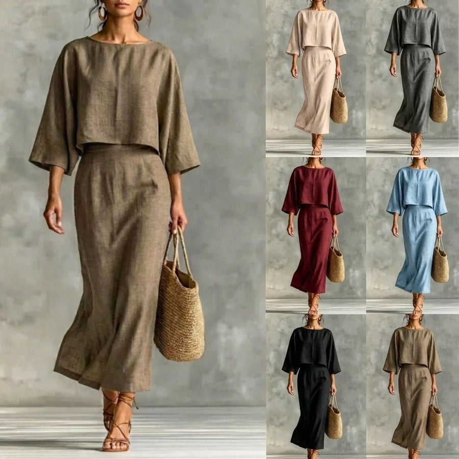 A woman wearing a linen high waist long skirt and 3/4 sleeve loose top matching set in a solid neutral color.