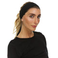 Close up of a Merino Wool Tie Headband in Microweight fabric, worn as a sweatband for outdoor activity.