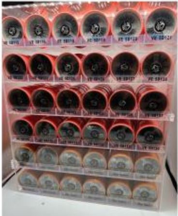 A clear 36-slot acrylic display organizer on a neutral background, showcasing minimalist home storage style.