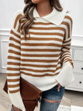 A woman wearing a brown and white horizontal striped sweater with a collared neckline and long sleeves.
