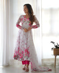 Model wearing a white organza kurta set with detailed sequin embroidery and matching dupatta