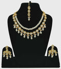 Luxury gold plated Kundan set with hand-set stone accents on a display