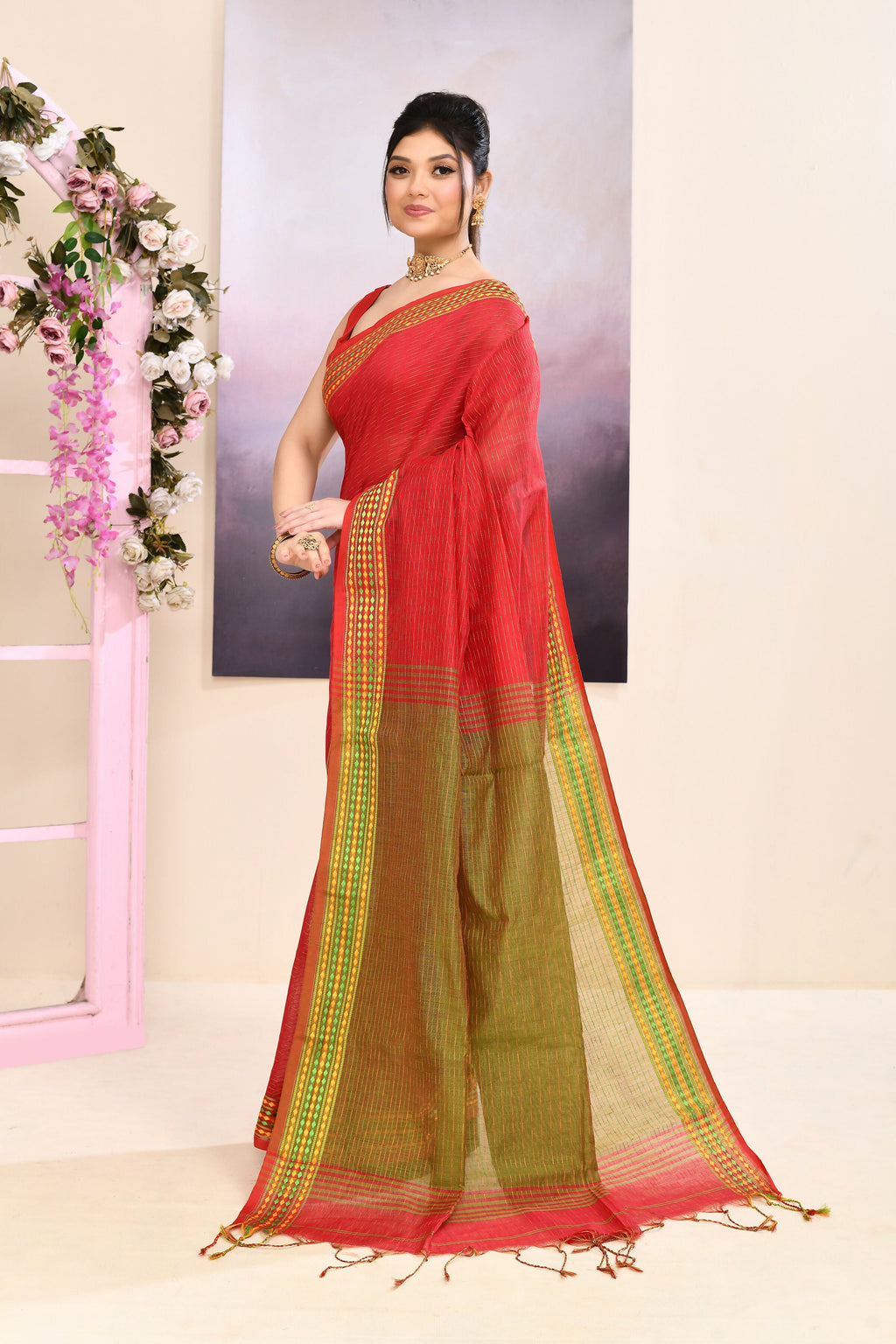 Classic red cotton blend Jamdani saree with elegant embellishments.