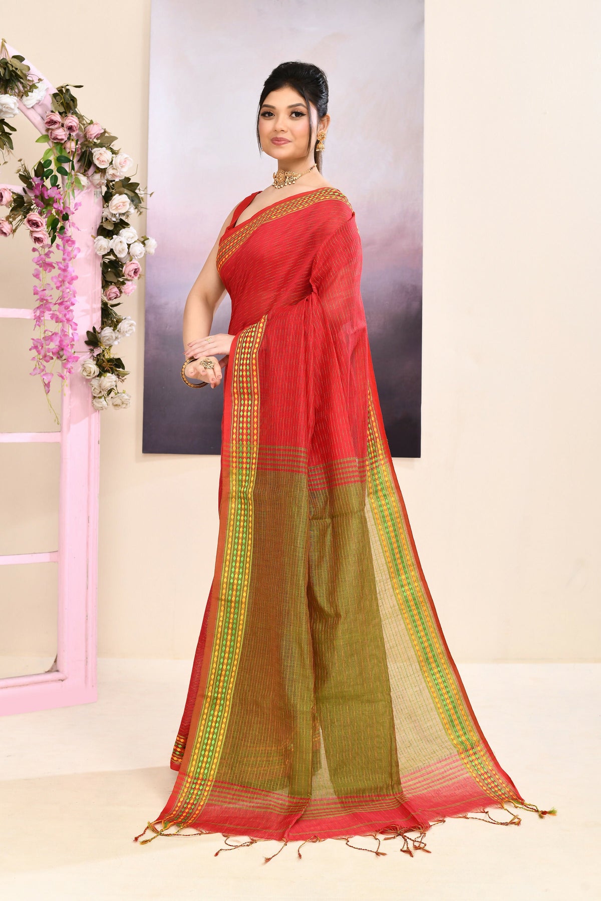 Classic red cotton blend Jamdani saree with elegant embellishments.