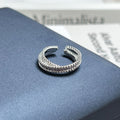 Adjustable open ring featuring purple fire rhinestones in a modern designer style.