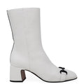 A pair of white leather boots with a 2-inch block heel, black back stripe, and horsebit hardware detail