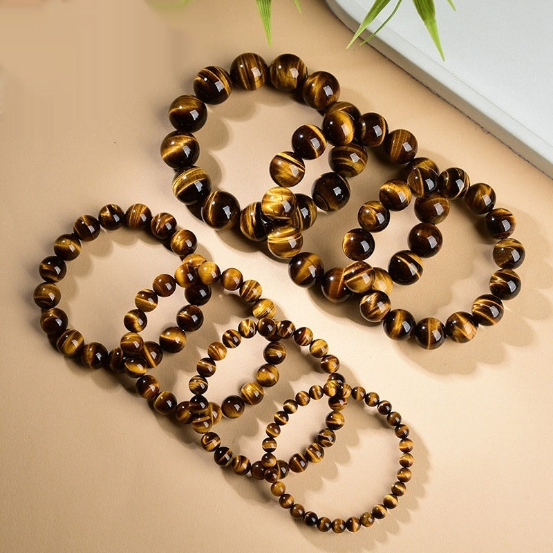 Close up of a polished natural Yellow Tiger Eye stone bead bracelet in 5A grade
