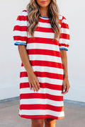 Model wearing a red, white, and blue striped shift mini dress with ruffled sleeves.