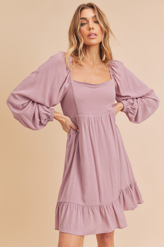 Feminine mini dress with square neckline, balloon sleeves, and ruffled hem