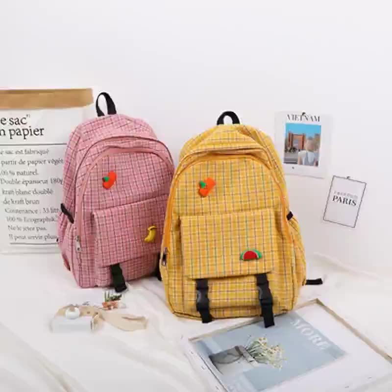 A vibrant Harajuku style plaid backpack in yellow and pink, ideal for school students, showcasing its large capacity and trendy design.