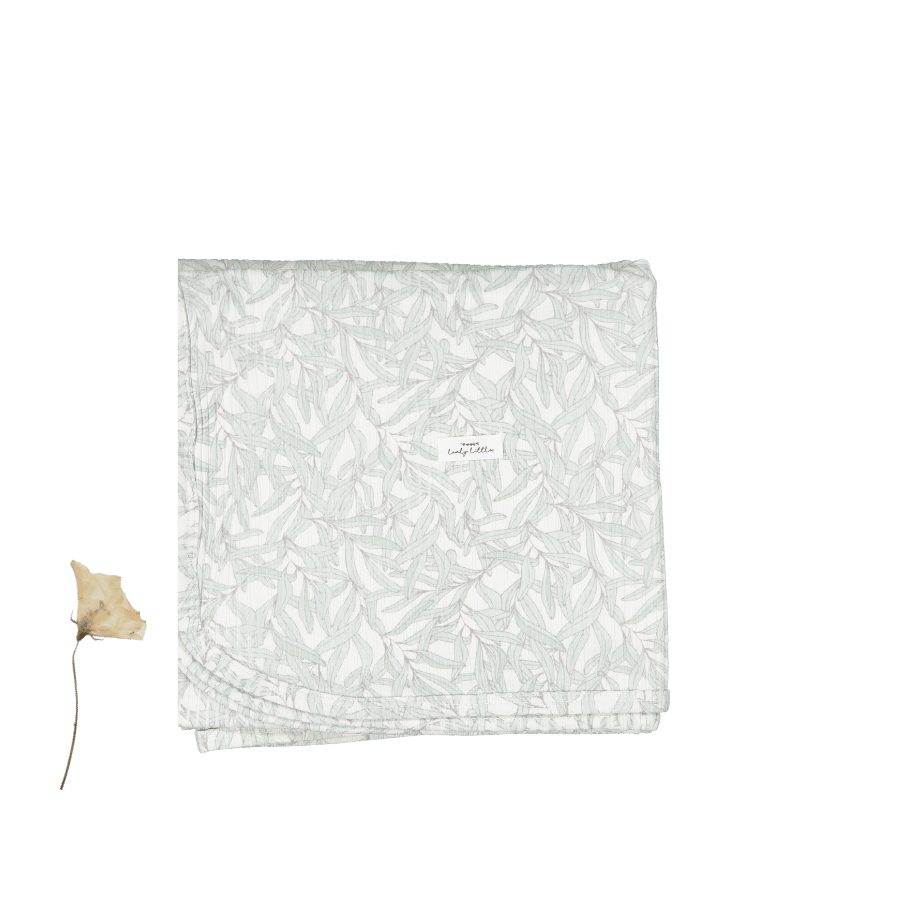 Willa printed ribbed cotton baby swaddle blanket with leafy botanical pattern on white background