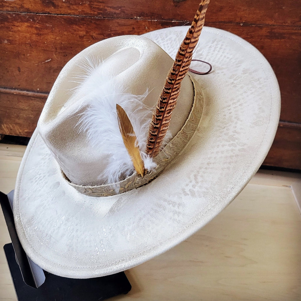 Hand-painted gold western cowgirl hat with python print texture, feathers, and detailed band