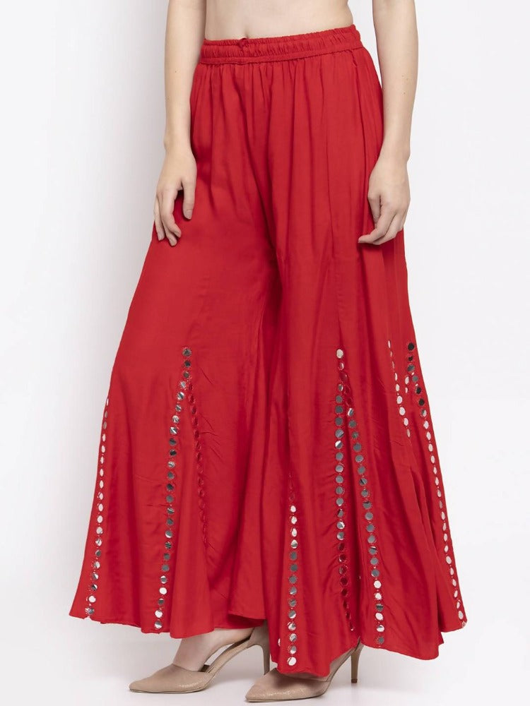 Red wide-leg palazzo pants with decorative mirror embellishments
