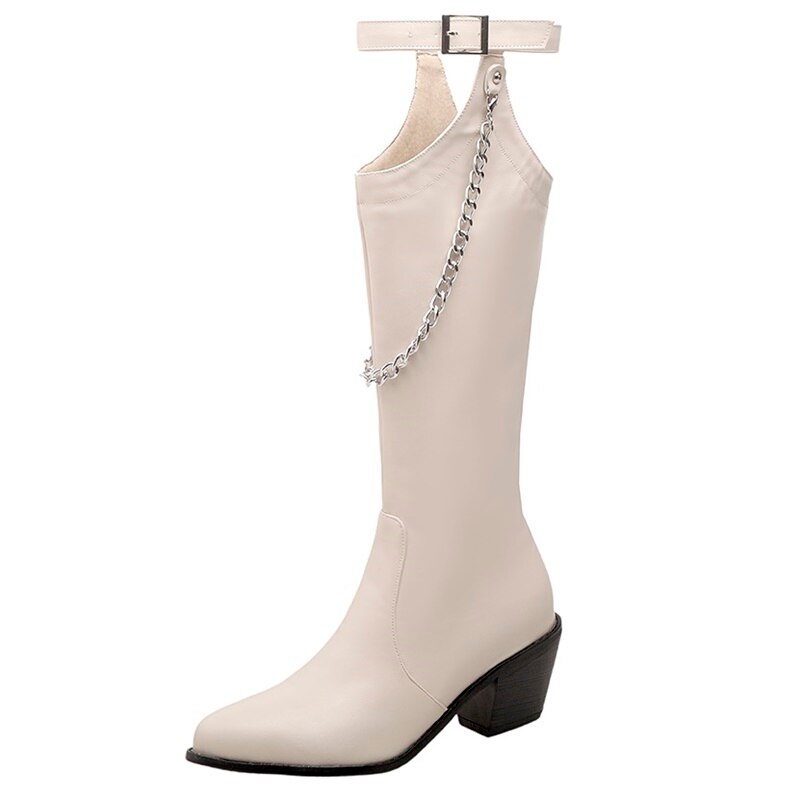 Women's black and white pointed toe high heel boots with decorative silver chain and buckle strap on a white background.