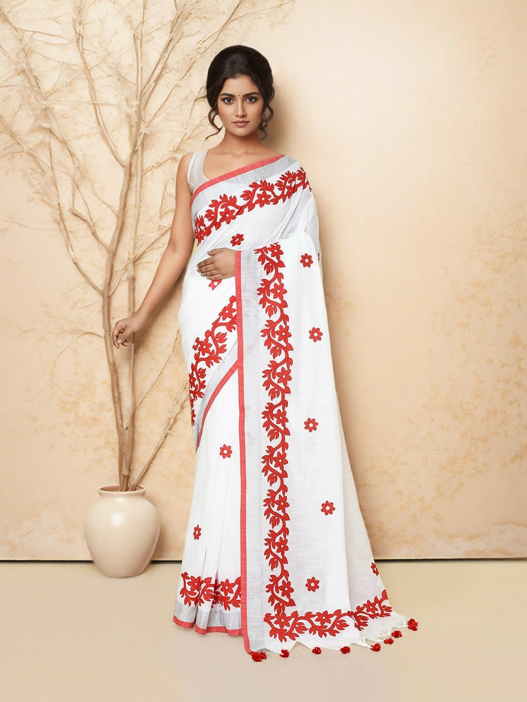 Draped Joban Fashion white and red cotton applic saree featuring detailed artisan fabric work.