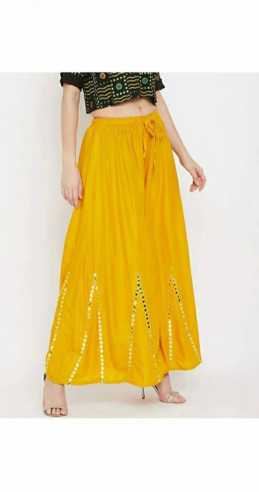 Woman wearing yellow palazzo pants with decorative mirror work embroidery