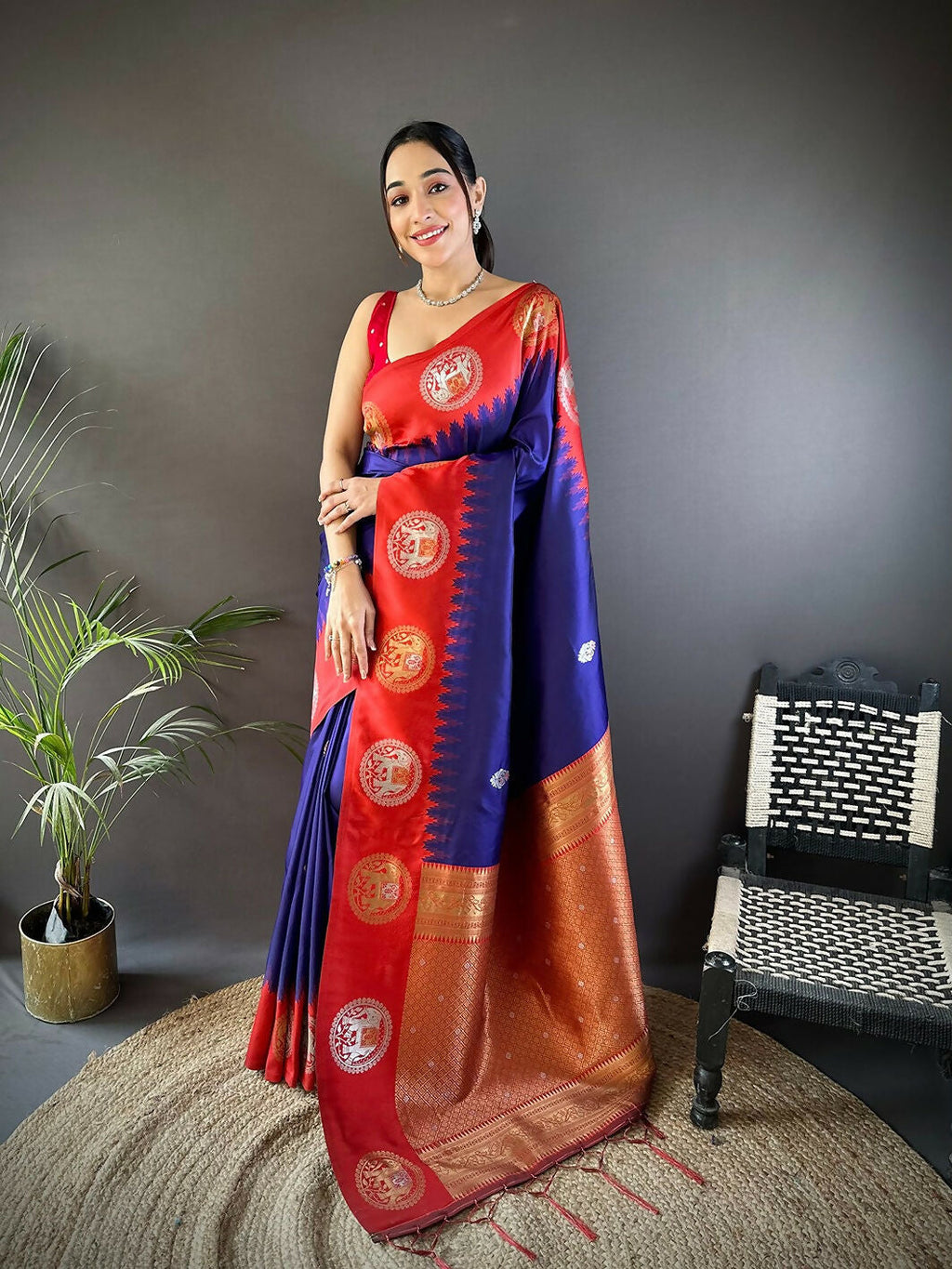Full view of red butti Banarasi silk saree with accompanying unstitched blouse