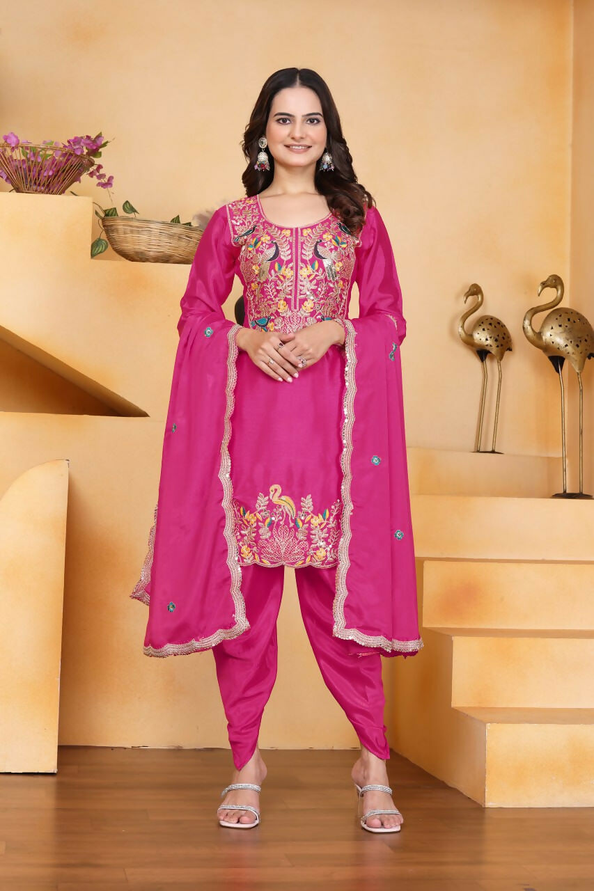 Woman wearing a pink silk embroidered kurti paired with dhoti pants