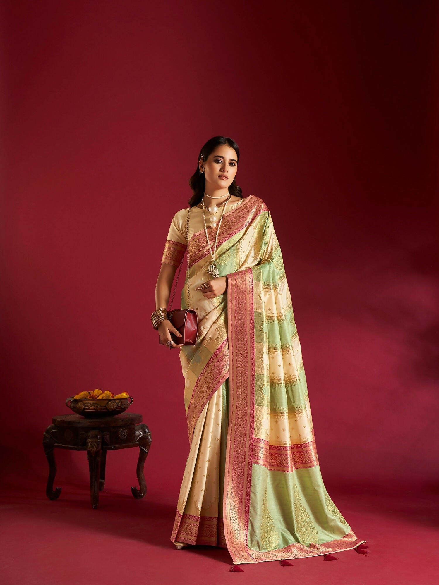 Cream and Sea Green soft silk saree featuring a delicate traditional weaving border