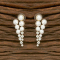 A pair of elegant golden brass earrings featuring white AD stones for women
