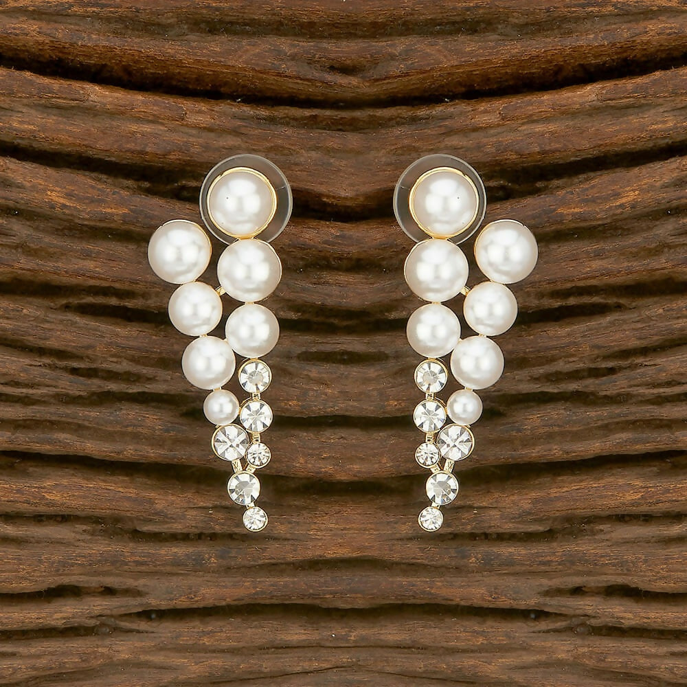 A pair of elegant golden brass earrings featuring white AD stones for women