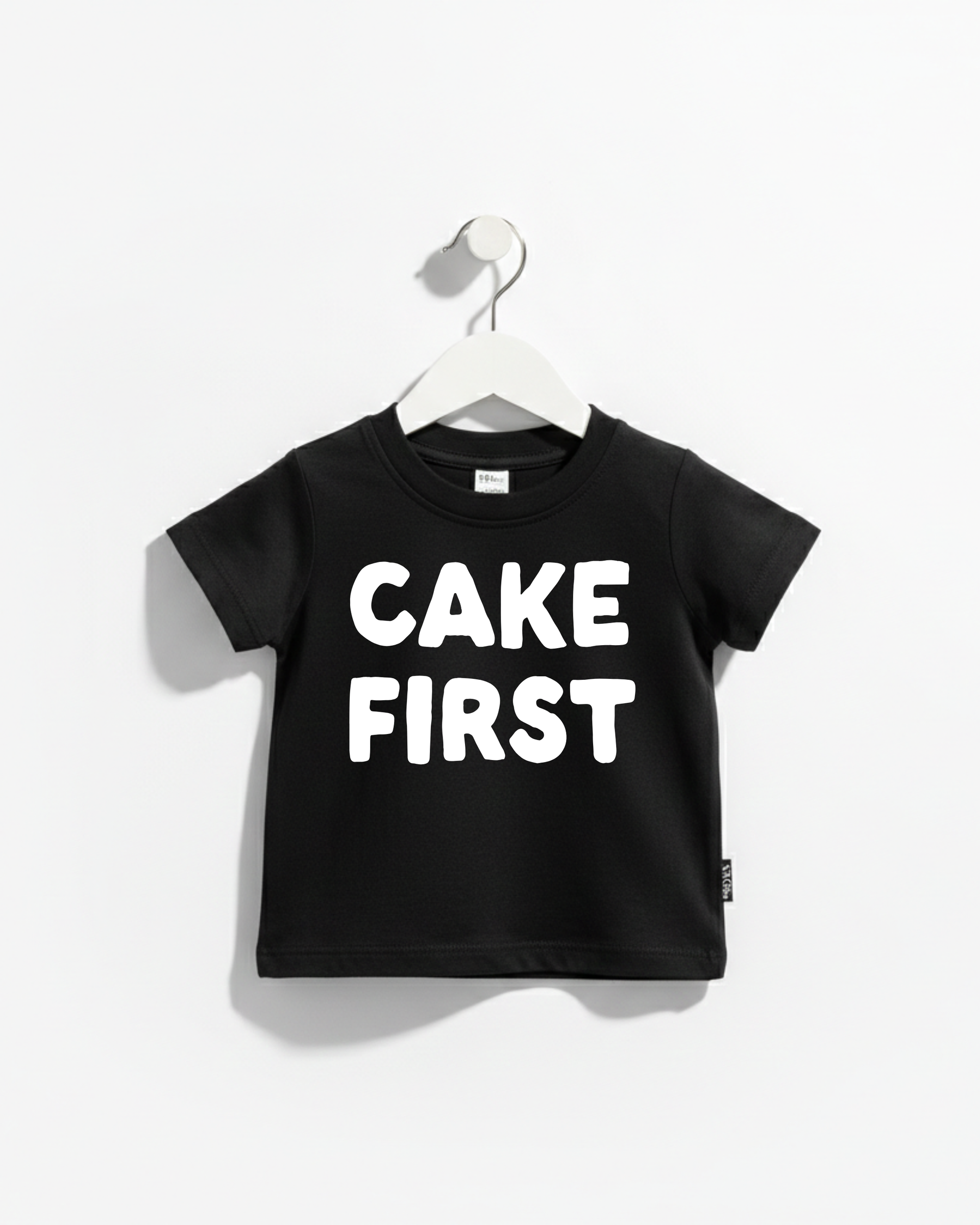A black and white Cake First kids' graphic cotton t-shirt, perfect for birthday celebrations.