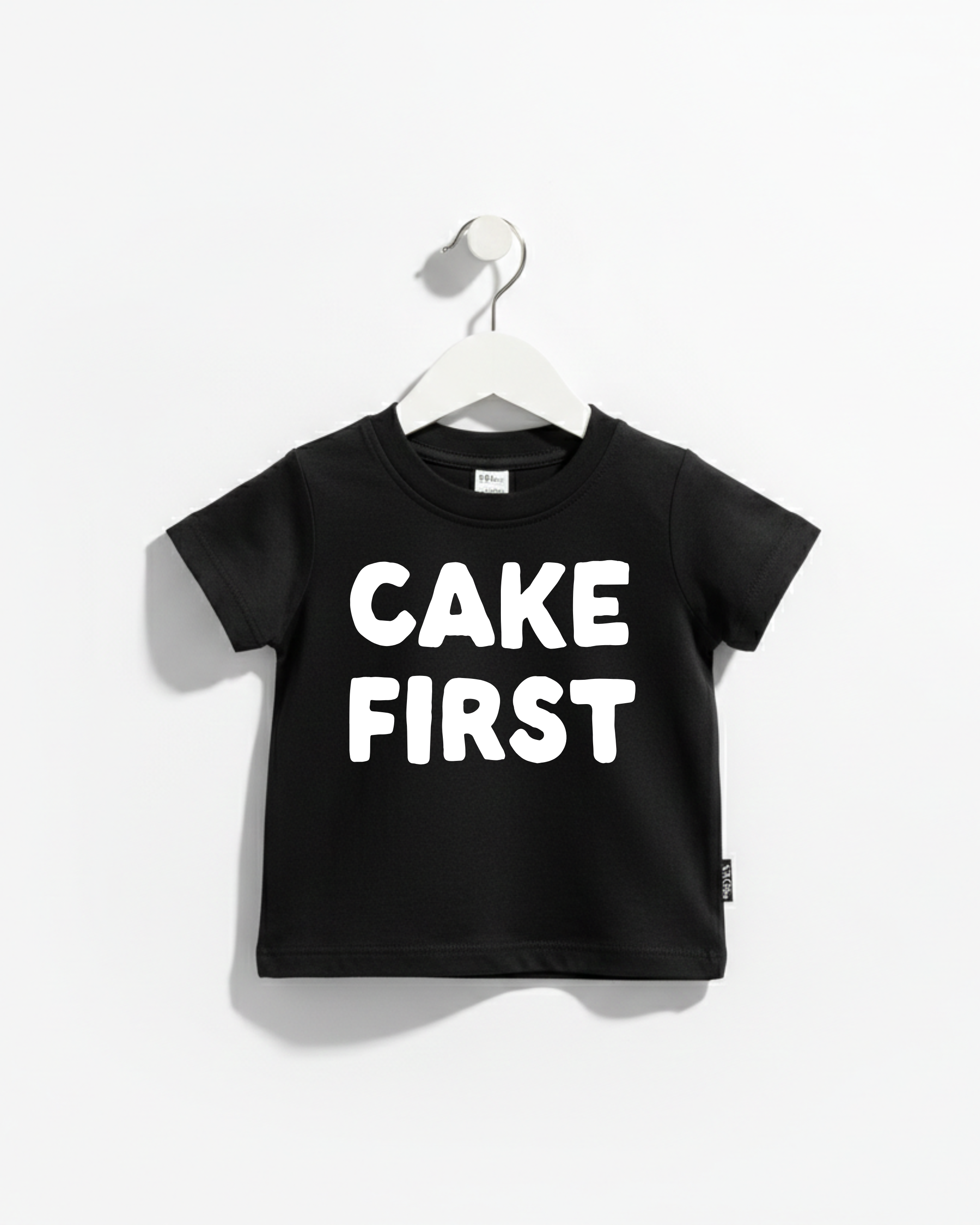 A black and white Cake First kids' graphic cotton t-shirt, perfect for birthday celebrations.