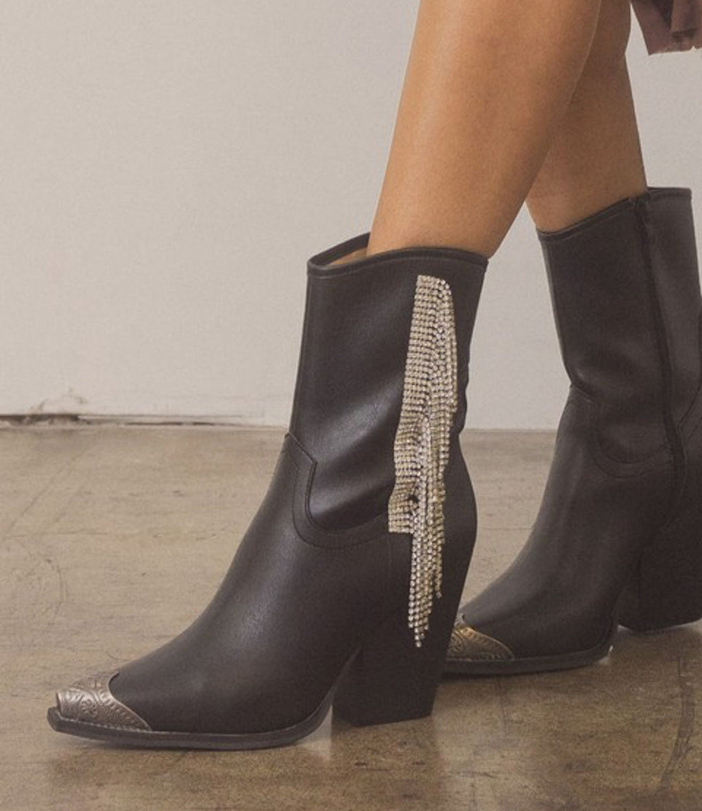 Black ankle boots featuring rhinestone fringe detailing and an etched toe cap in a Western style.