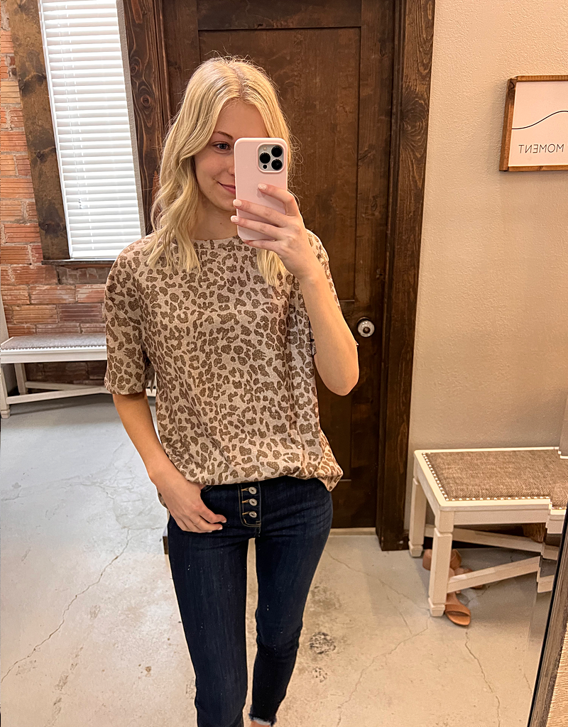 Khaki leopard print short sleeve t-shirt with a round neckline, shown against a neutral background.