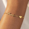 Minimalist gold personalized name bracelet worn by a woman for a romantic, casual aesthetic.