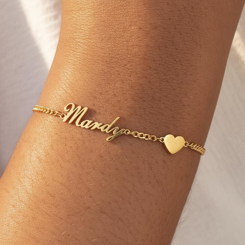 Minimalist gold personalized name bracelet worn by a woman for a romantic, casual aesthetic.