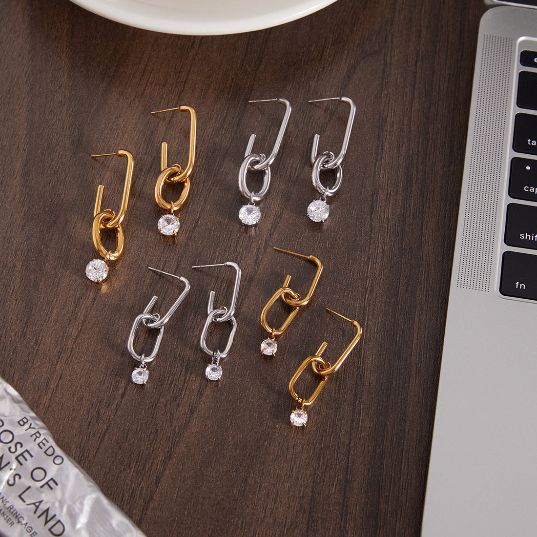 Modern stainless steel geometric hoop earrings with a single zircon drop
