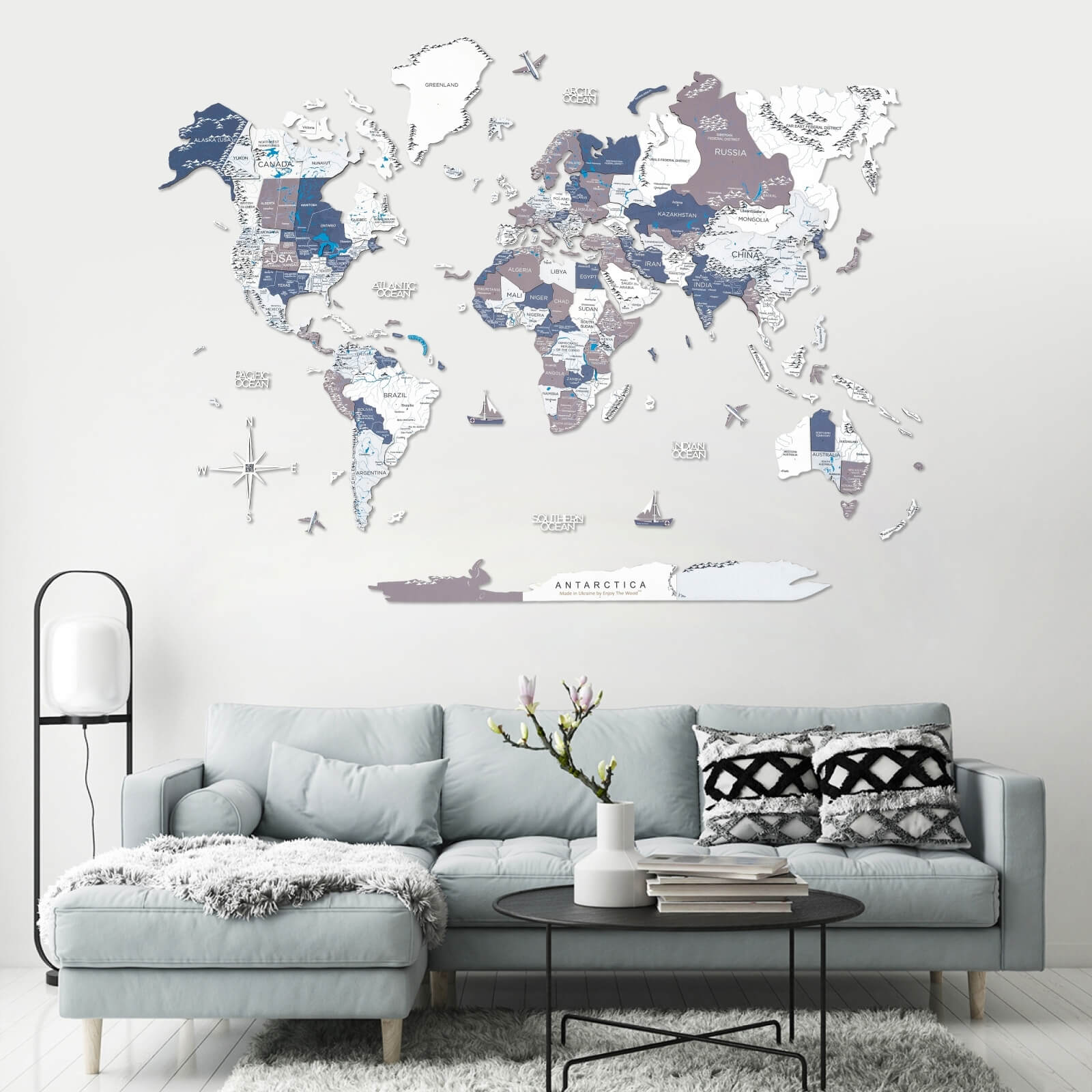Modern 3D wooden world map in coastal tones of blue, grey, and white.