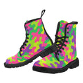 Pair of women's neon rainbow camouflage lace-up combat boots with black laces and durable black rubber soles.