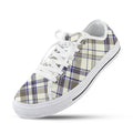 Pair of Women's Collegiate Plaid Low Top Canvas Sneakers with white laces and soles, featuring blue and brown plaid pattern on a cream background.