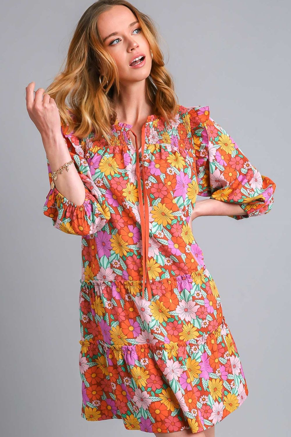 Feminine floral print tiered dress with ruffled details and tie neck