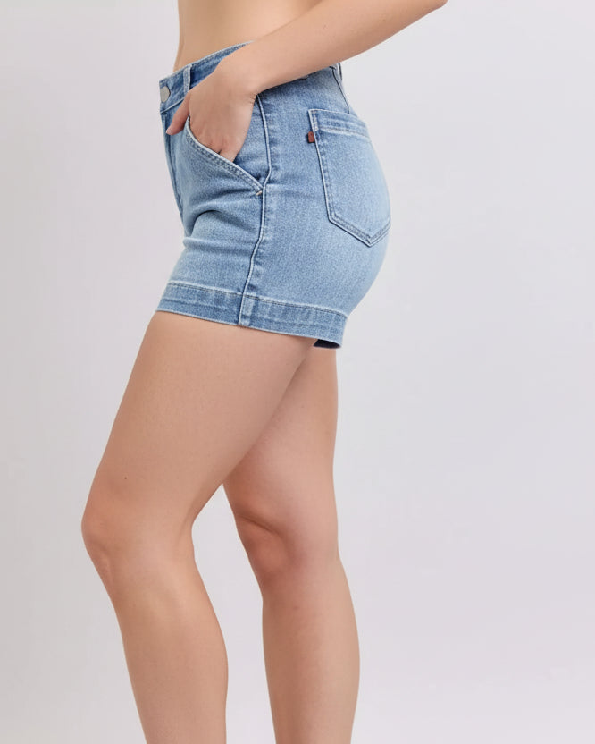 Light blue denim shorts worn by a person on a white background