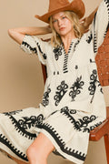 Vintage-inspired cream and black floral printed midi dress with a notched neckline