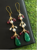 A pair of elegant multicolor Kundan and pearl drop earrings with intricate brass detailing.