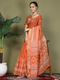 Woman wearing a solid vibrant orange cotton saree with matching blouse