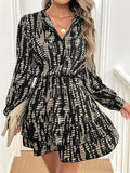 Sleek black and beige abstract print long sleeve mini dress worn in a modern setting.