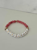 Let Go Let God Bracelet with pink marbled glass beads and gold sequined cross accents.