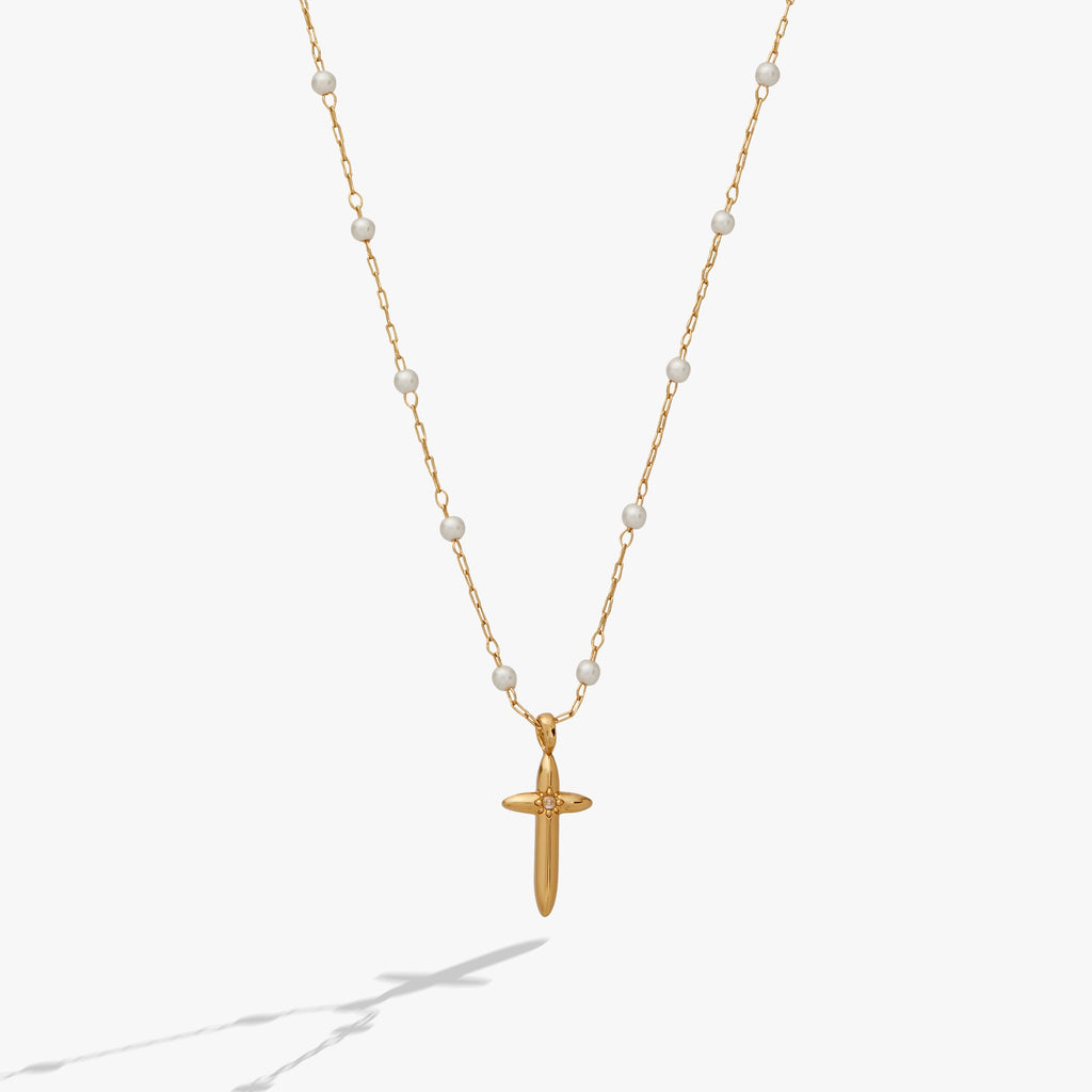 Gold-plated cross pendant with white pearl rosary beads on a delicate chain