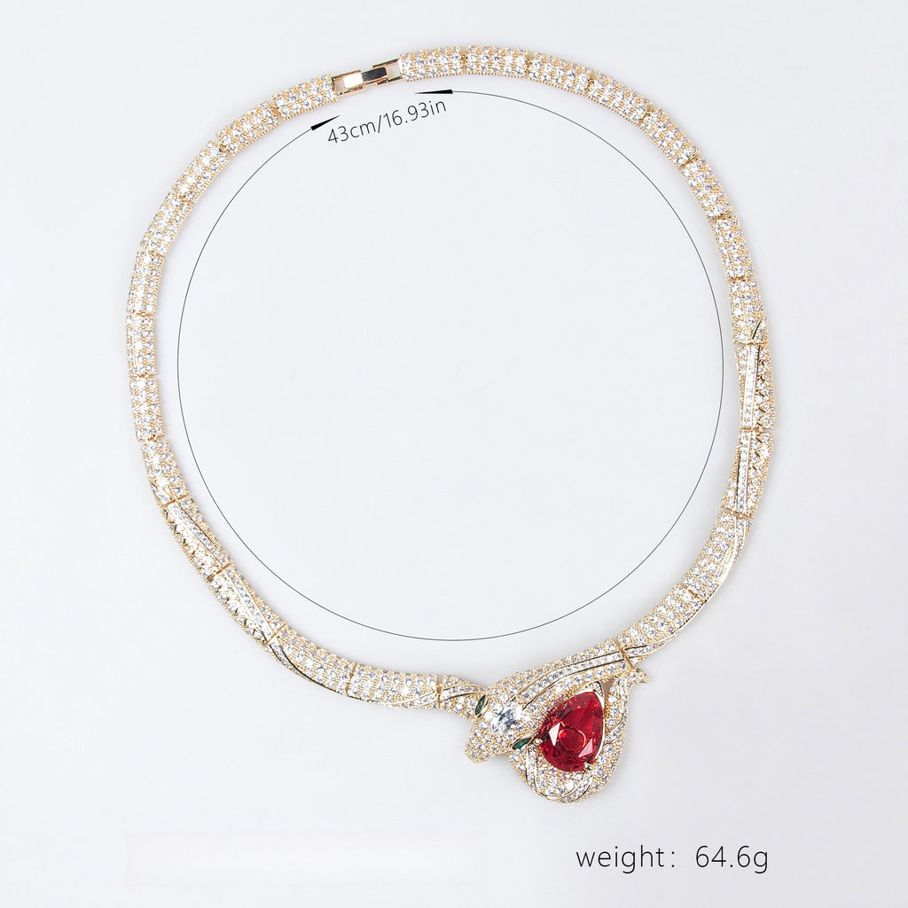 Close up of 18K gold necklace featuring snake and bamboo knot design with zirconia accents by Vera Lux