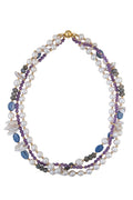 Three-strand necklace featuring freshwater pearls, purple amethyst beads, blue lapis stones, grey labradorite, and small gold beads.